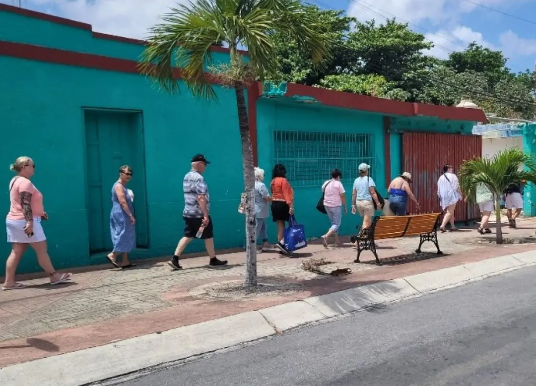 Men and women of all ages walking safely on a side street in Cozumel, Mexico.