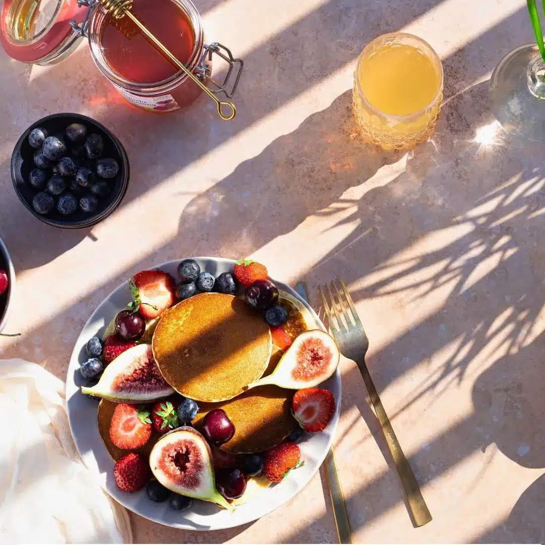 Suites Colonial boutique hotel with outdoor garden breakfast under bougainvillea, near Cozumel cruise port.