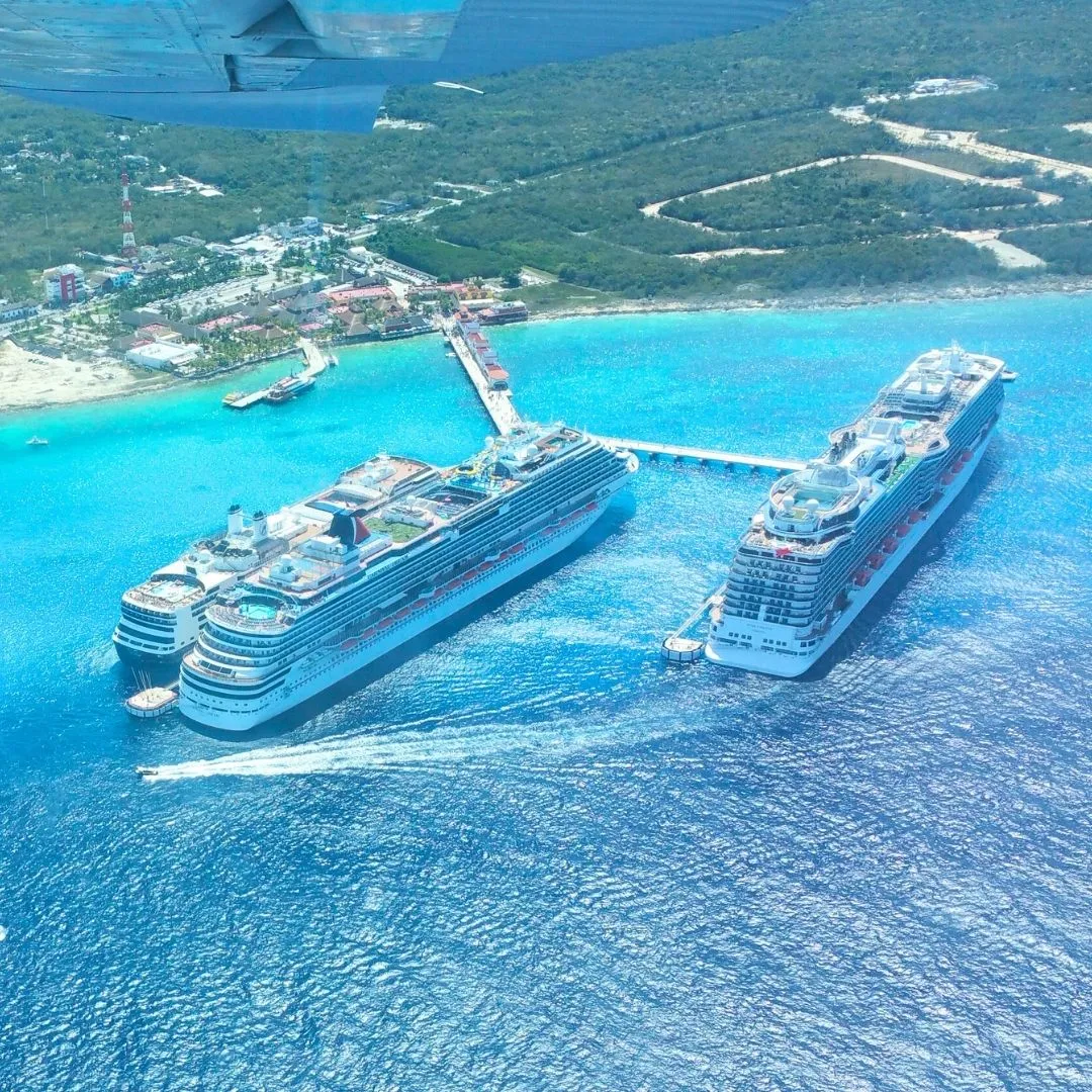 Aerial view of Cozumel cruise ports showing multiple cruise ships docked at western piers